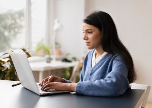 woman at desk using a laptop